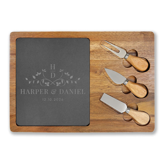 Wooden cutting board with slate surface and cheese knives on a white background, personalize with names