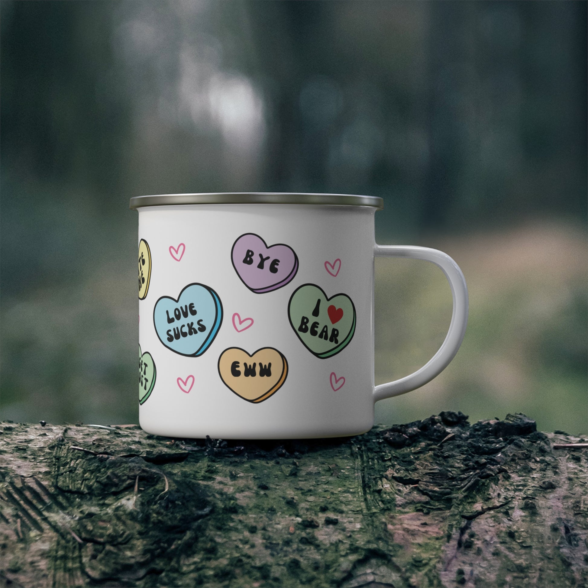 White mug with colorful heart-shaped designs on a tree stump in a forest setting, anti valentines day hearts