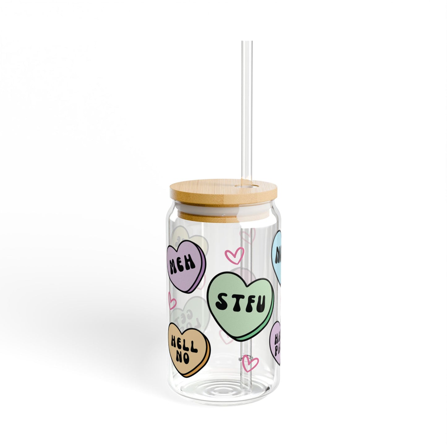 Clear tumbler with colorful heart-shaped stickers and a wooden lid on a white background, anti valentines candy heart messages