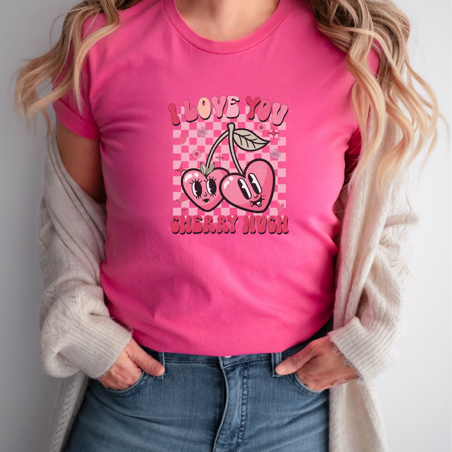 Person wearing a pink t-shirt with cherry design and text. i love you cherry much