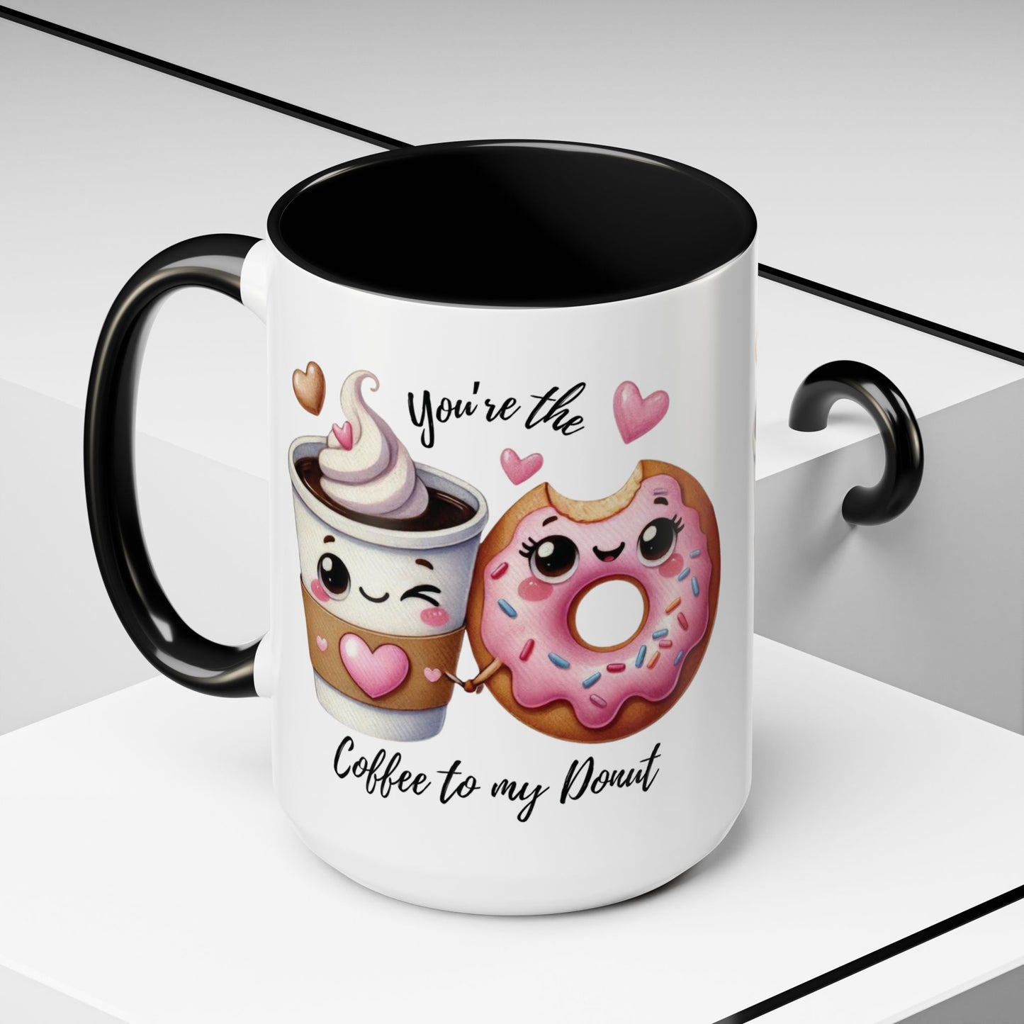 Mug with cartoon coffee cup and donut, text 'You're the coffee to my donut', on a light background
