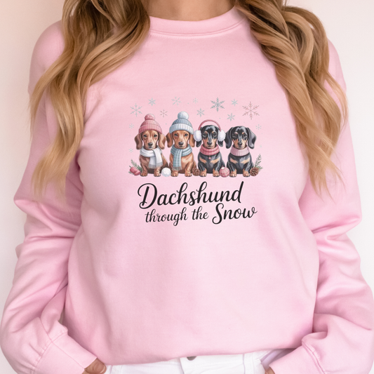Pink sweatshirt with dachshund design and text 'Dachshund through the Snow' 