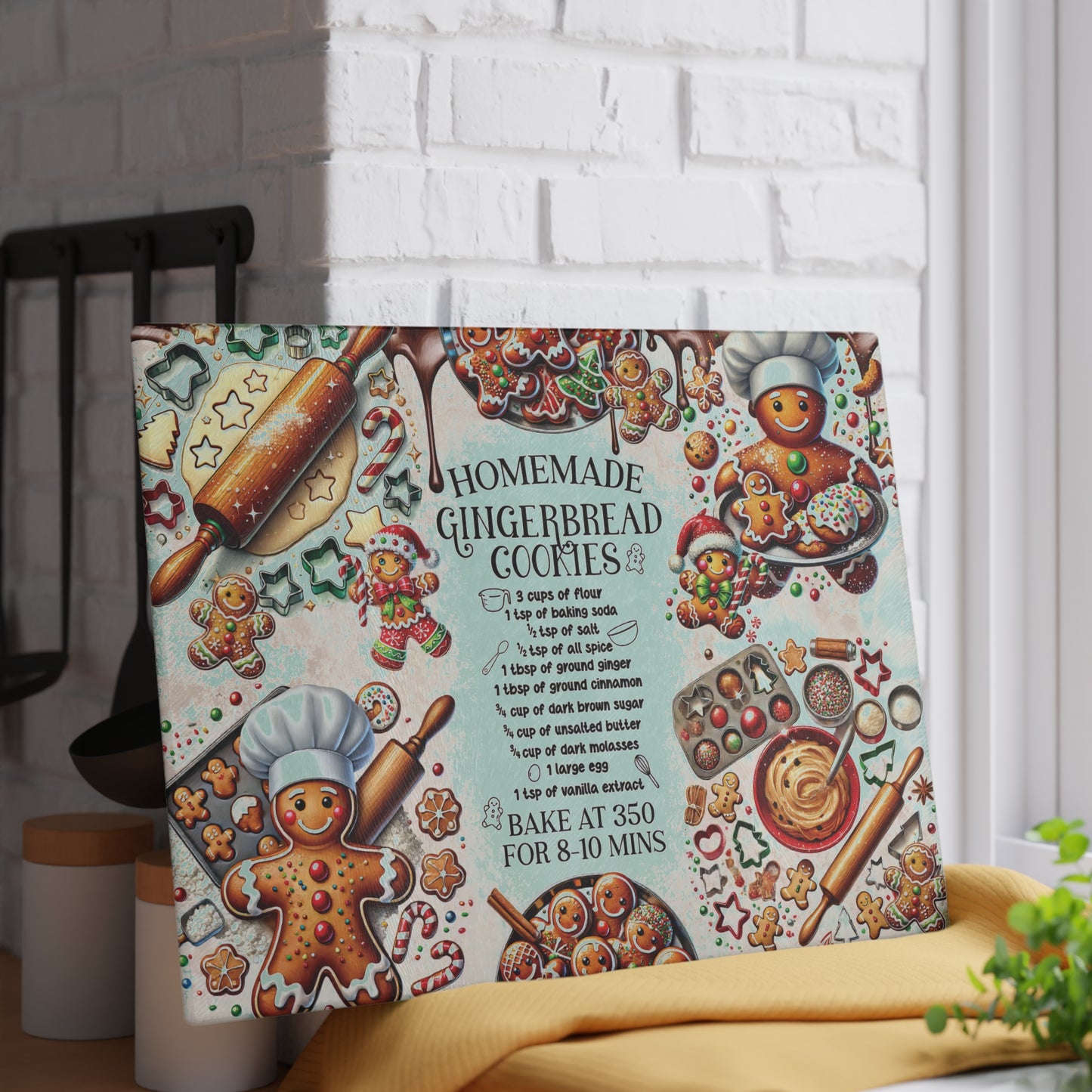 Decorative gingerbread-themed kitchen towel with recipe on a white brick wall background.