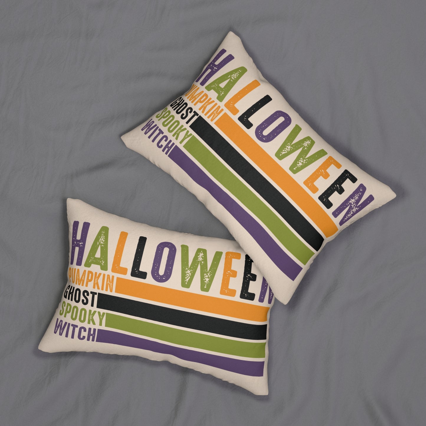 Two Halloween-themed decorative pillows on a gray surface. halloween word collage lumbar pillow