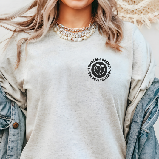 Person wearing a light gray sweatshirt with a black circular design and text.  I might be a handful but so is this ass