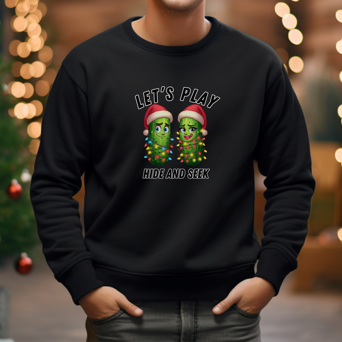 Person wearing a black sweatshirt with Christmas-themed design in front of blurred festive lights.