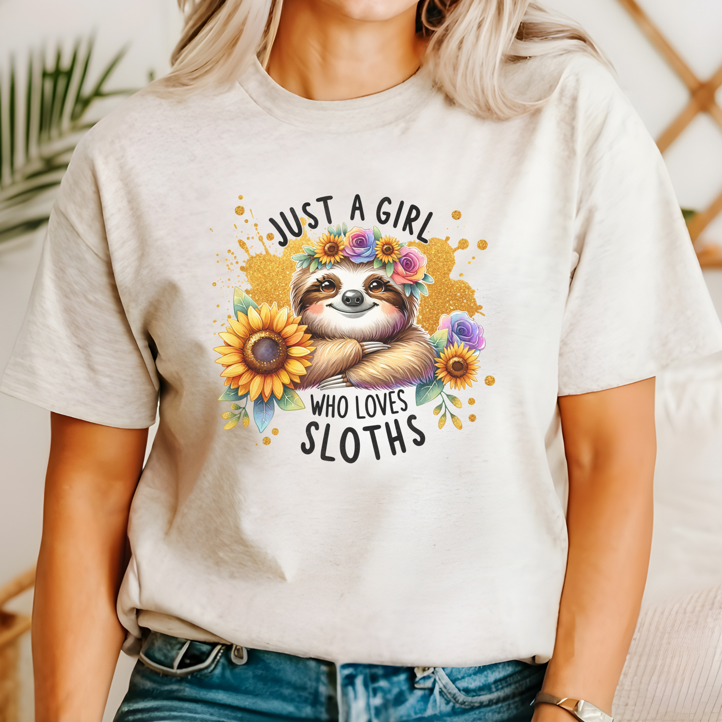 Person wearing a t-shirt with a sloth graphic and text 'Just a Girl Who Loves Sloths'.