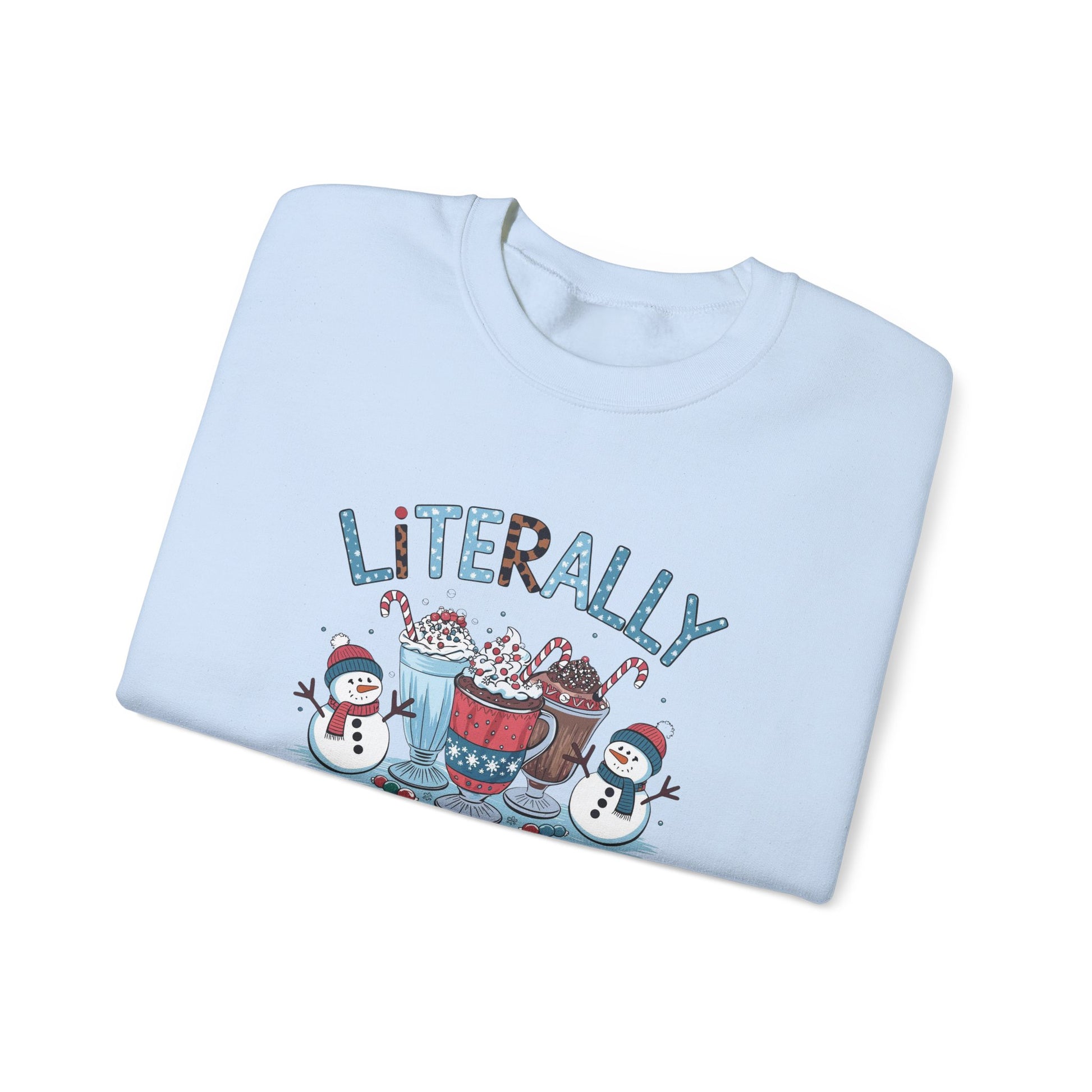 Folded light blue sweatshirt with 'LiTERALLY Freezing' text and winter-themed graphics on a white background
