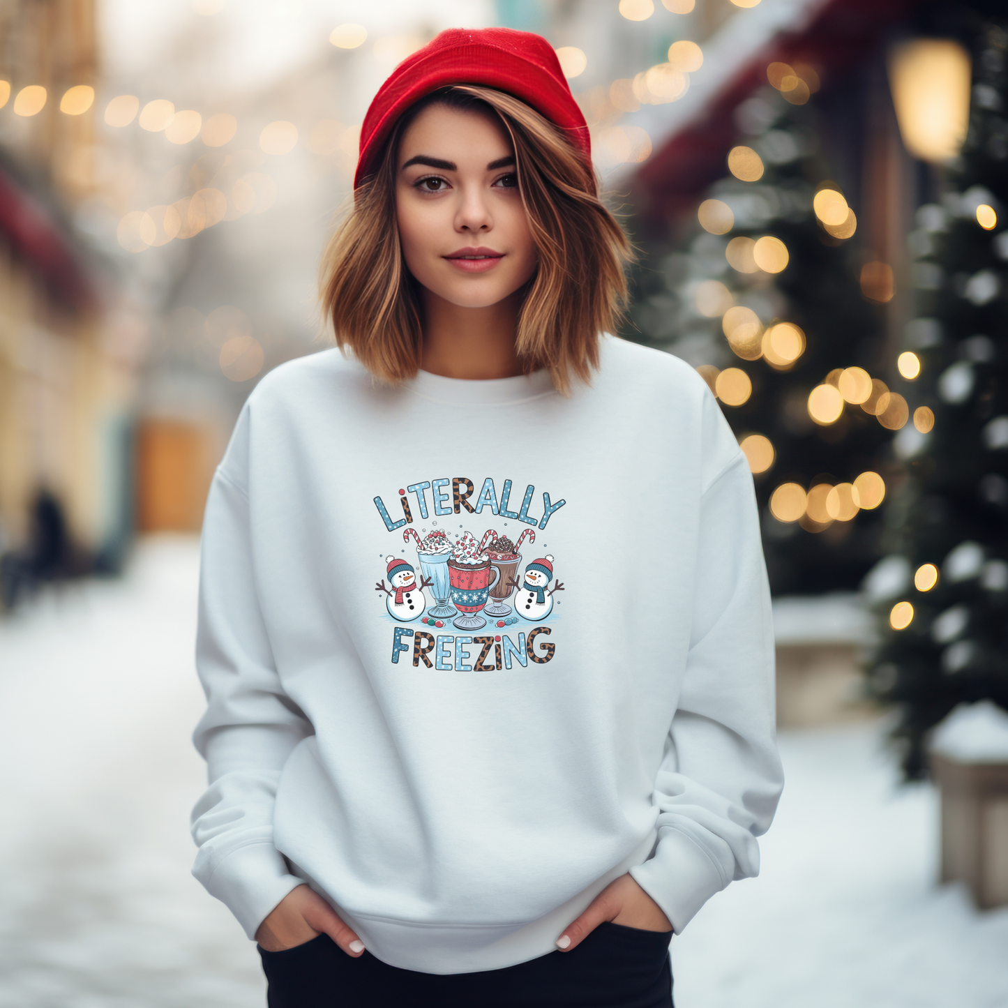 woman wearing a white sweatshirt with  a literally freezing text with snowman and cocoa graphics