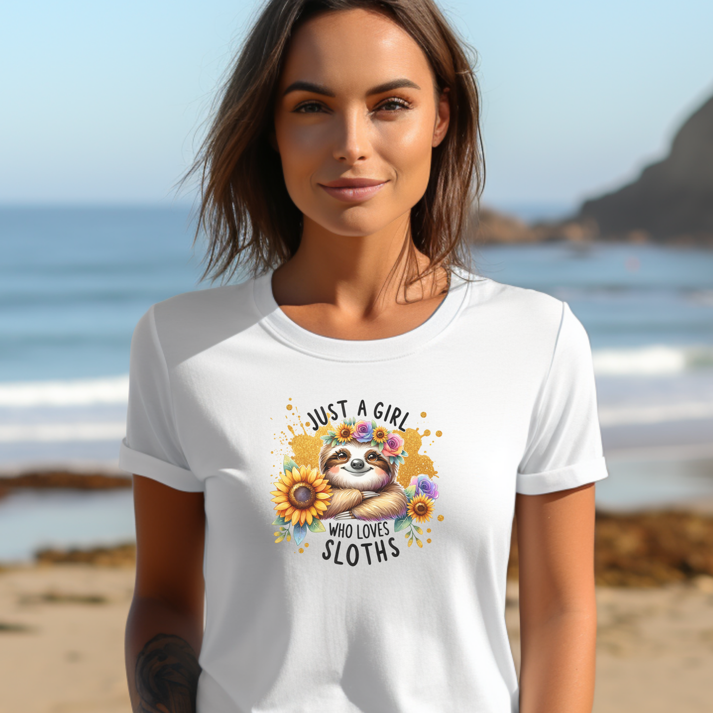 Woman wearing a white t-shirt with a sloth graphic and text on a beach. just a girl who loves sloths