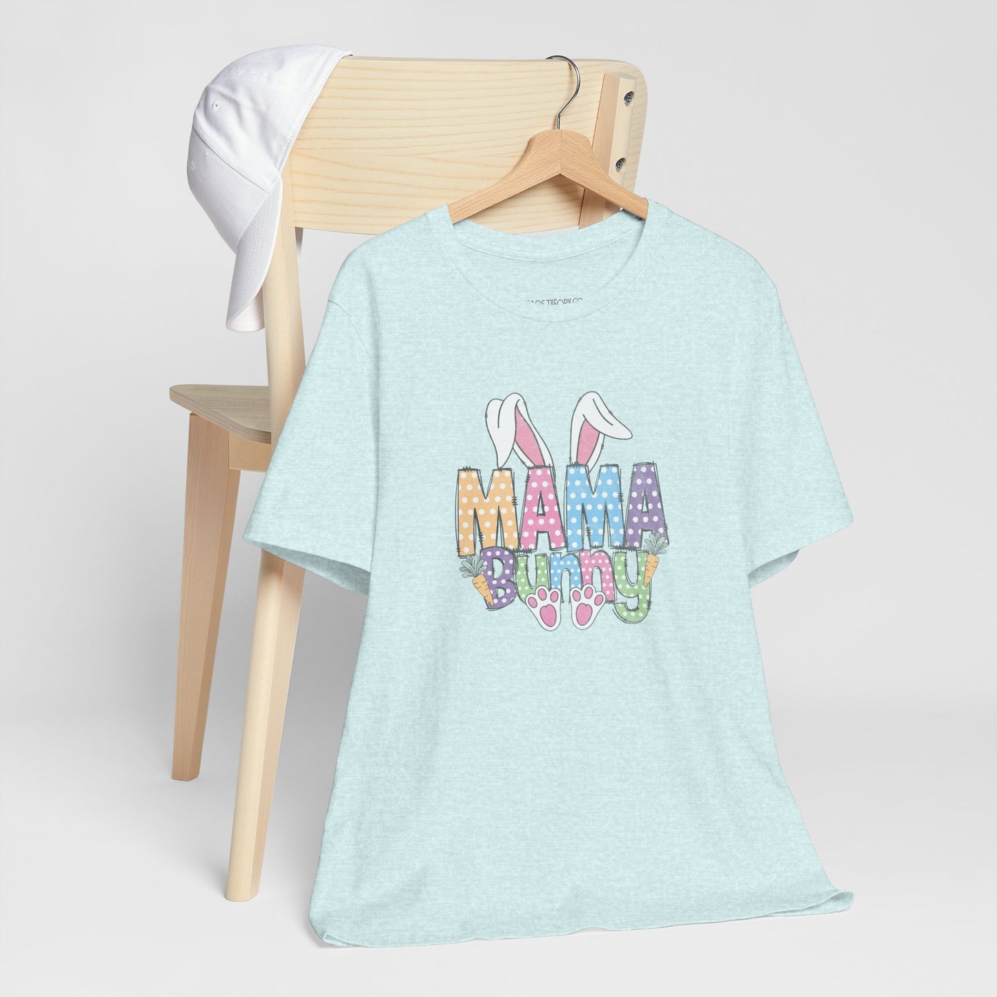 Light blue t-shirt with 'Mama Bunny' text on a wooden chair against a white background