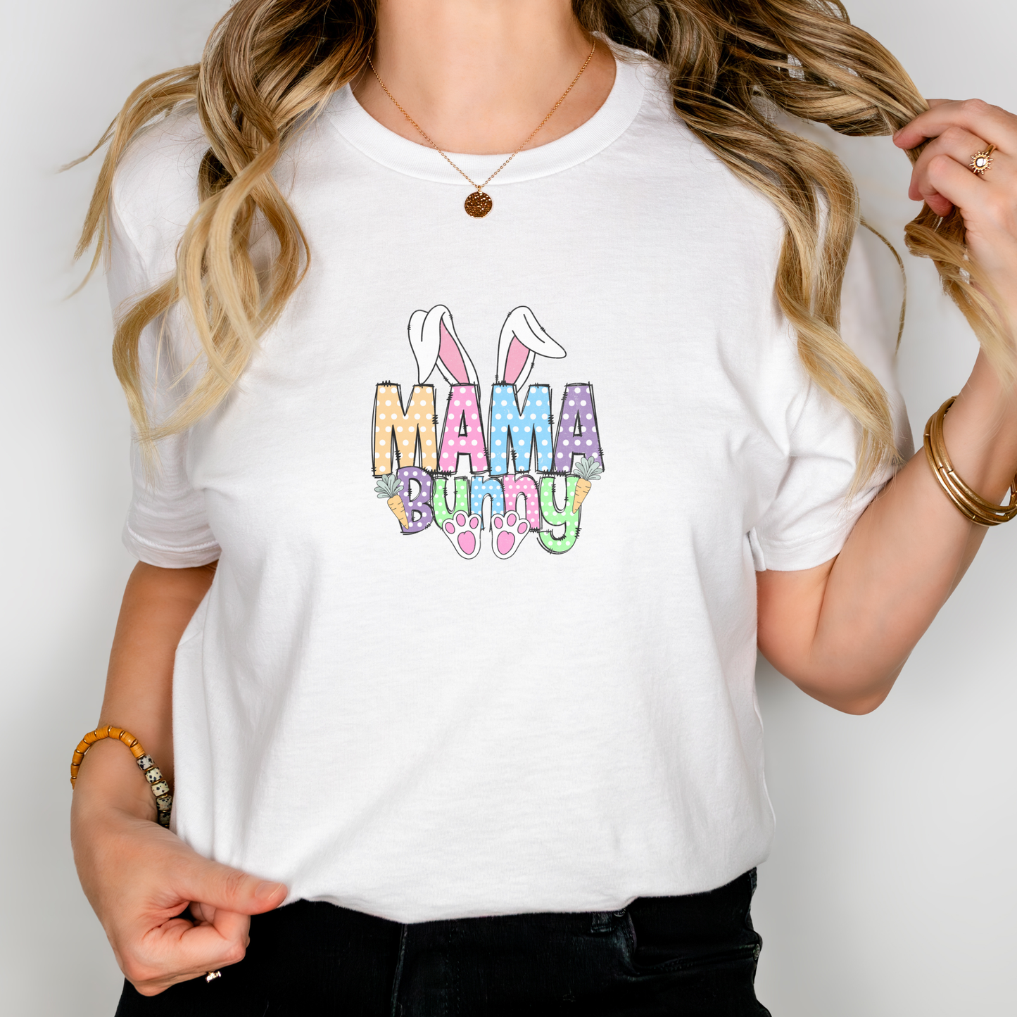Person wearing a white t-shirt with 'Mama Bunny' text and colorful design.