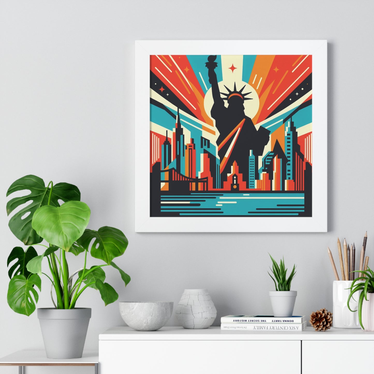 Framed poster of a stylized cityscape with a silhouette of a famous landmark, placed on a shelf with decorative items. nyc burst abstract art, white frame