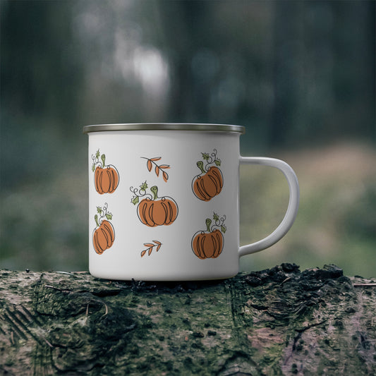White mug with pumpkin design on a tree stump in a forest setting