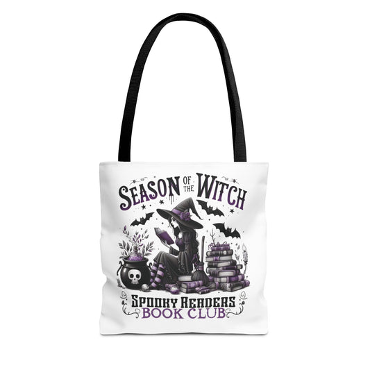 Tote bag with Halloween-themed design featuring a witch, books, and text on a white background. season of the witch spooky readers book club