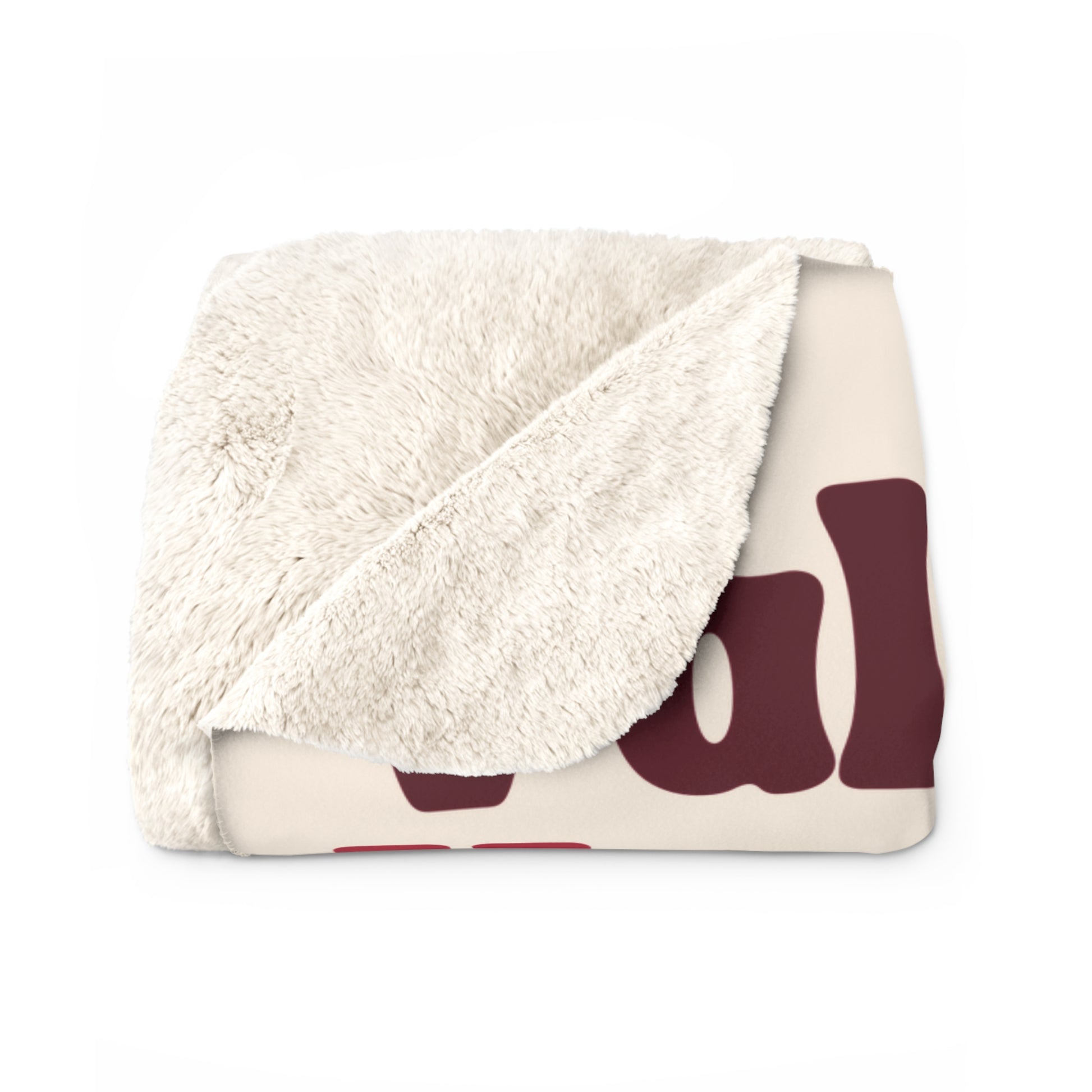 Folded blanket with white sherpa interior and burgundy abstract pattern on cream background, valentines word collage
