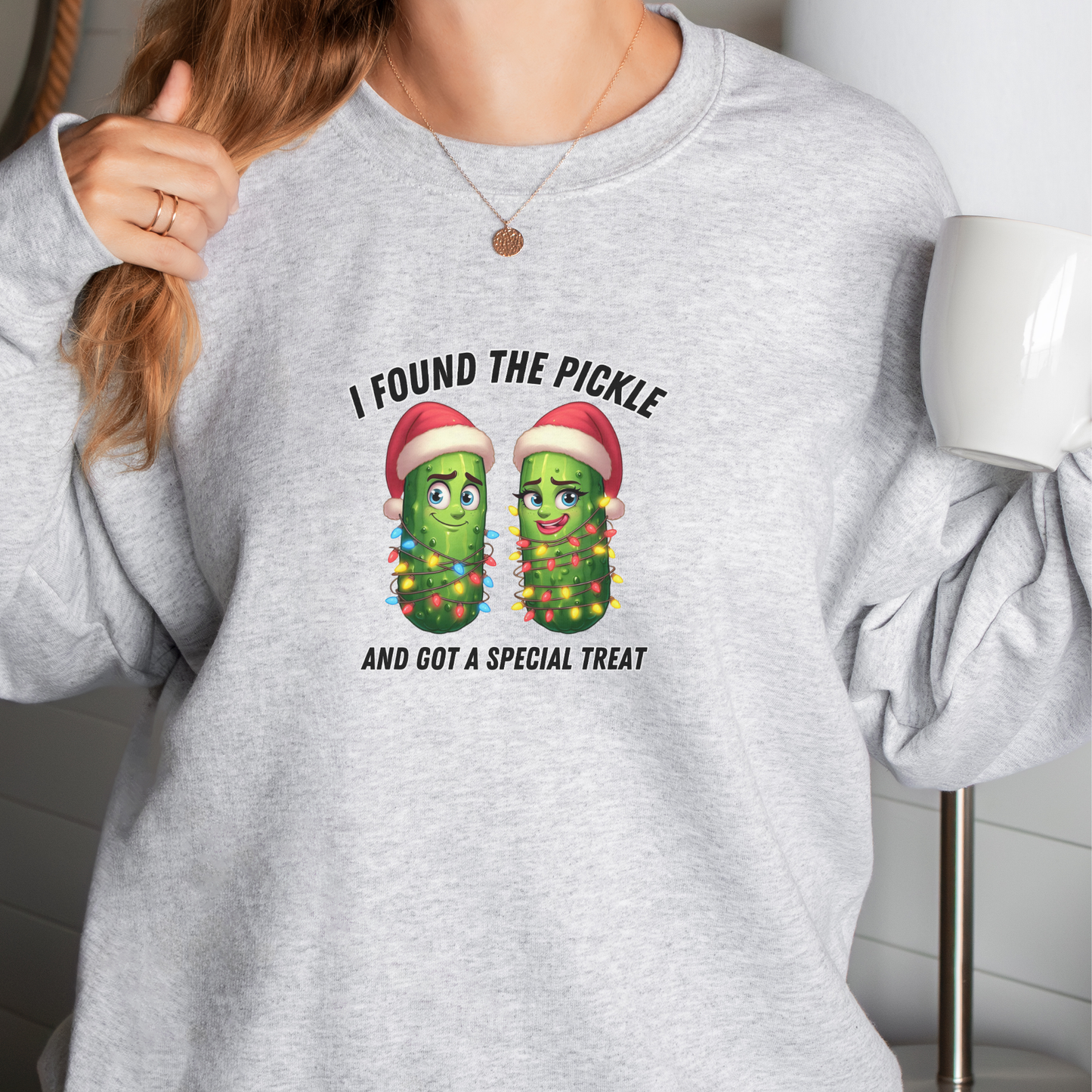 Person wearing a gray sweatshirt with pickle design and text